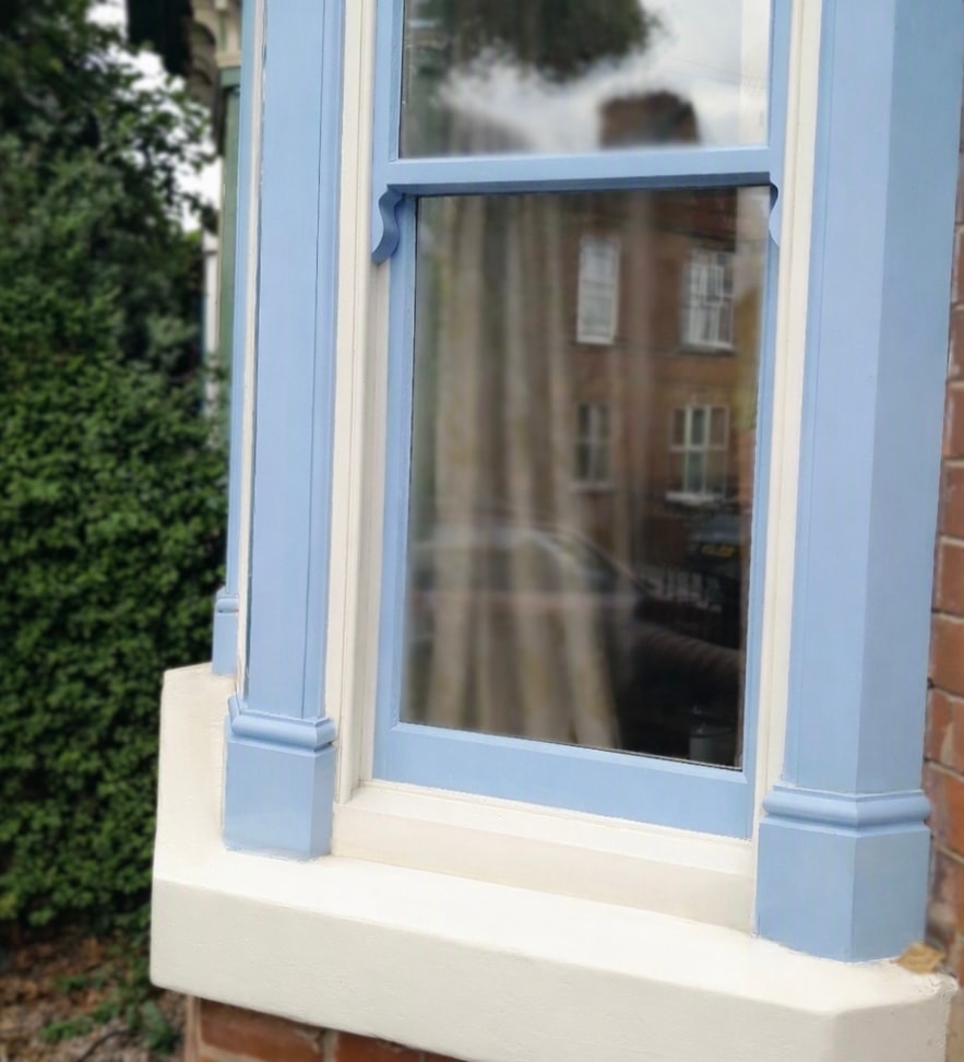 Blue painted sash window exterior with draught seal fitted at meeting rail