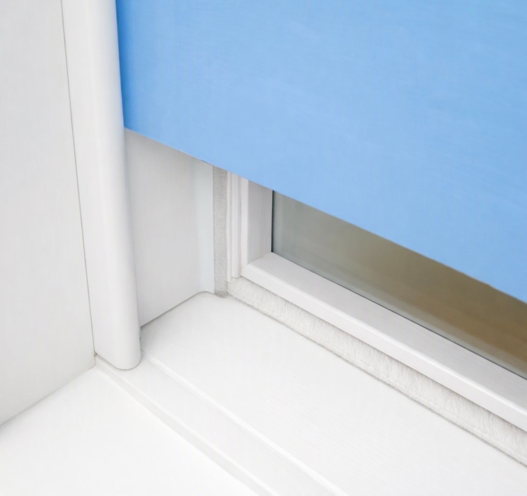Bottom rail of sash window showing brush pile draught seal installation